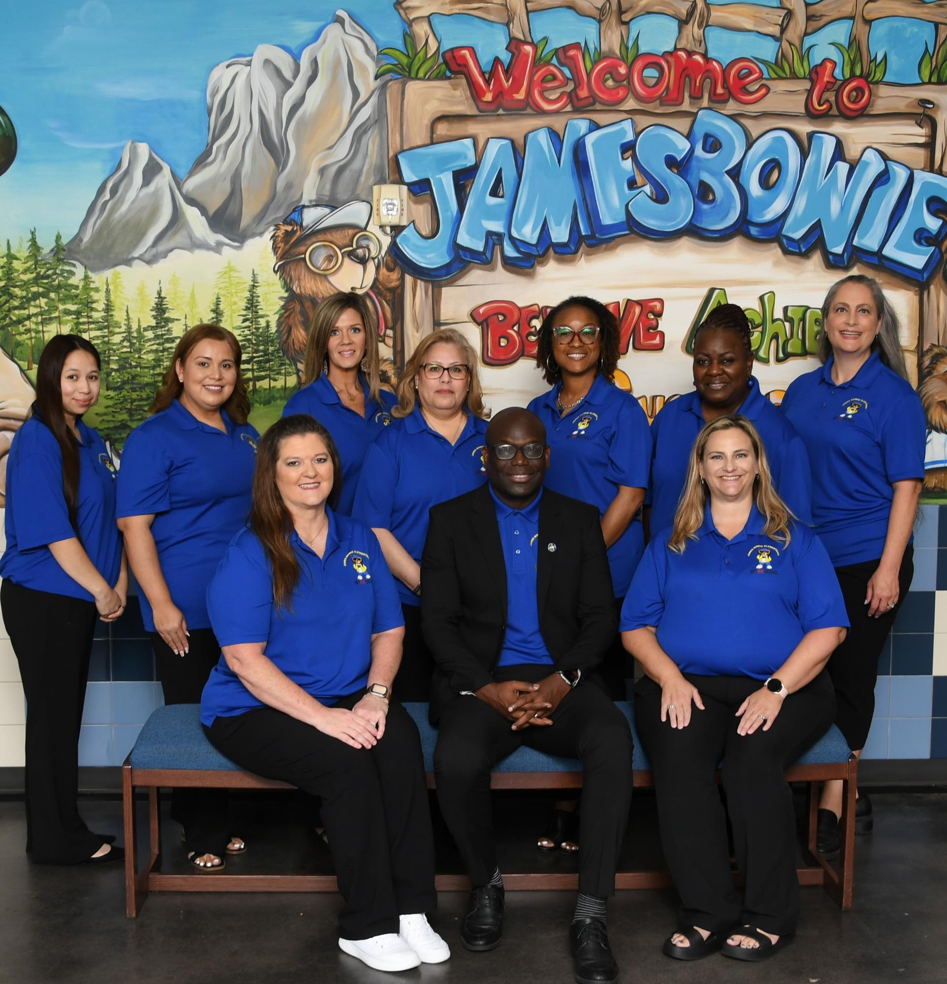 Office staff smiling and posing for a staff picture